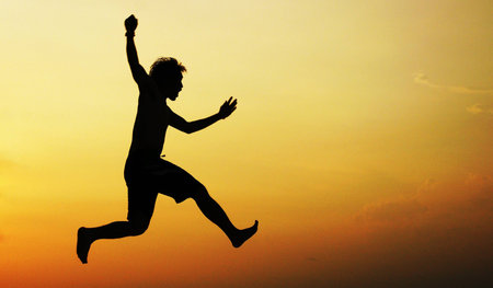 jumping to sky when sunsetの写真素材