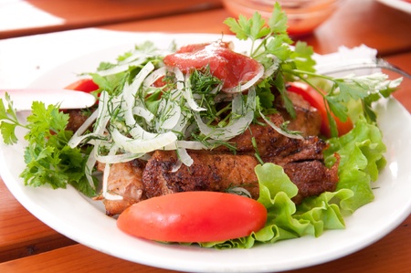Glilled meat with tomatoes and  lettuceの写真素材