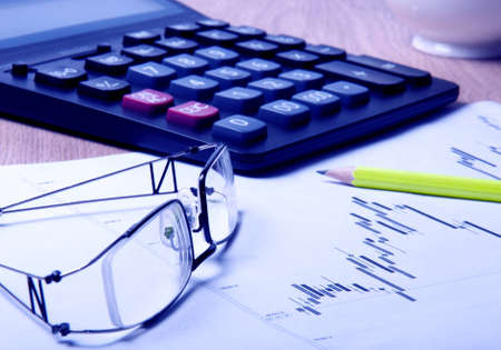 eyeglasses, calculator, pencil and diagram の写真素材
