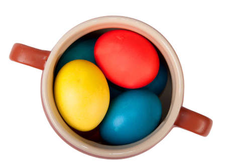 clay pot with easter eggs isolated on whiteの写真素材
