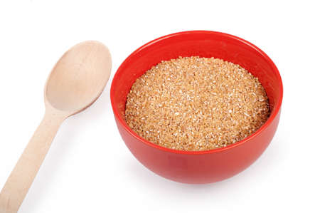 wheat grits in plate isolated on whiteの写真素材