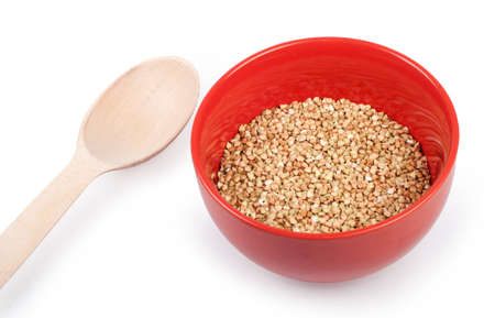 Raw buckwheat in plate isolated on whiteの写真素材