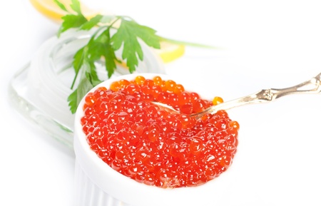 Fresh golden red caviar isolated on whiteの写真素材