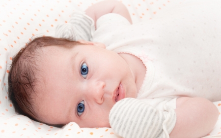 Cute blue-eyed newborn baby. Can be used in journal or packaging or as postcard concept.の写真素材