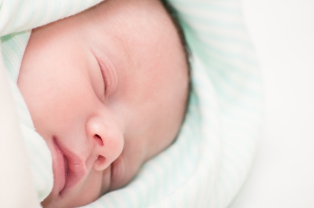 Cute blue-eyed newborn baby. Can be used in journal or packaging or as postcard concept.の写真素材