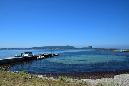 Panorama of Capo Falcone Cape viewed from the bay at Fornelli Harbor at Asinara National Park, Asinara Island, Sardinia, Italyの写真素材