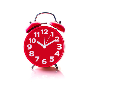 Red alarm clock over whiteの写真素材