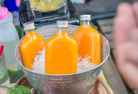 Orange juice in glass bottleの写真素材