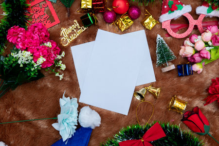 White blank christmas greeting card. A blank white paper decorated with a lot of christmas ornaments, colorful gift boxes. Blank space to fill. Christmas paper mockup imageの写真素材