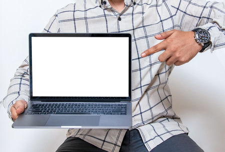 Image of a white blank screen laptop held by a man for mockupの写真素材