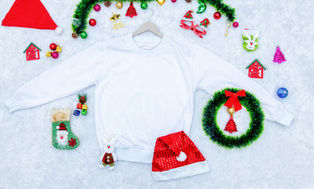 Blank sweatshirt mockup image with christmas themed decorations. A blank sweatshirt encircled by christmas ornaments, colorful gift decorations. Blank space to fill. Christmas sweatshirt mockup imageの写真素材