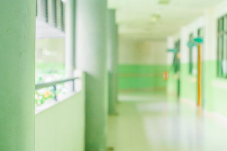 Defocused abstract background of a hallway with some pillars on the left. Blurred out indoor area backgroundの写真素材