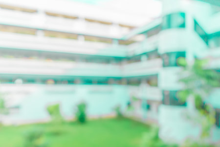 Defocused abstract background of a building with few plants in the frame. Blurred out building area backgroundの写真素材
