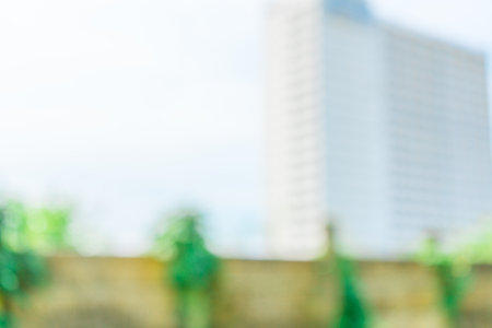 Defocused abstract background of an apartment with few trees in the frame. Blurred out apartment area backgroundの写真素材