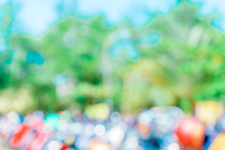 Defocused abstract background of a lot of motorcycles at the parking area. Blurred out park area backgroundの写真素材