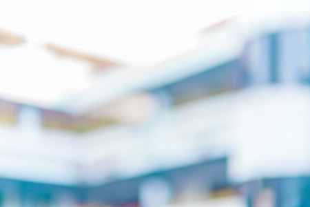 Defocused abstract background of a white tall building with few floors. Blurred out building area backgroundの写真素材
