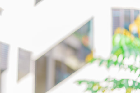 Defocused abstract background of a building with few plants in the frame. Blurred out building area backgroundの写真素材