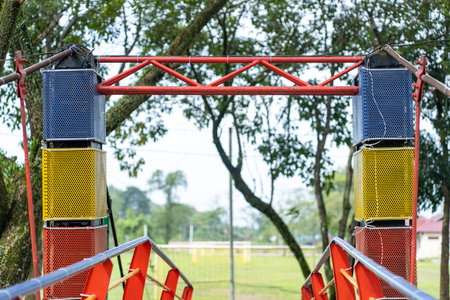 Two bridge pillars with colorful bright color standing strong with out of focus park background,...