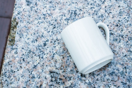 Coffee mug laying out on the top of the marble floor , coffee mug mockup image
