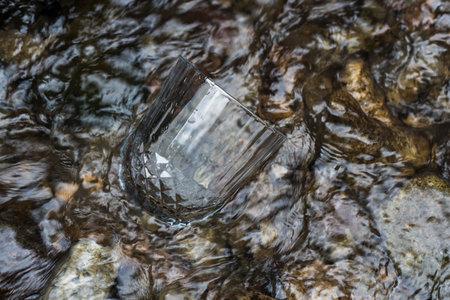 The beauty and versatility of a blank wine glass design are showcased in our stunning mockup images, featuring a transparent glass and natural sceneryの写真素材