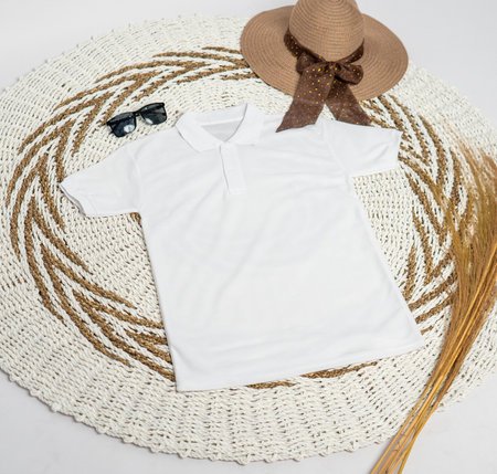 The flat lay polo shirt mockup highlights a clean and minimal design with subtle embellishments, presented in a stunning arrangementの写真素材