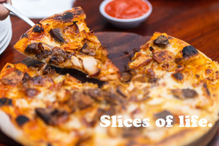 Pizza quote - Slice of life. With a serving of pizza as the out of focus background