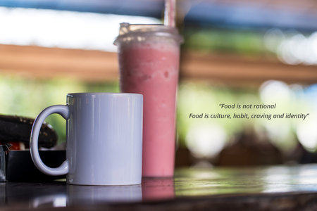 Food quote - Food is not rational. Food is culture, habit, craving and identity. With a white blank mug and a pink colored drinksの写真素材