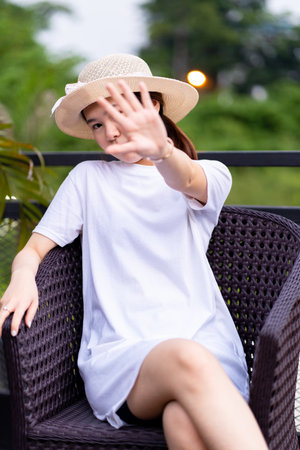 A beautiful Asian woman captured in a breathtaking pose for portrait photography, shirt dress mockup template imageの写真素材
