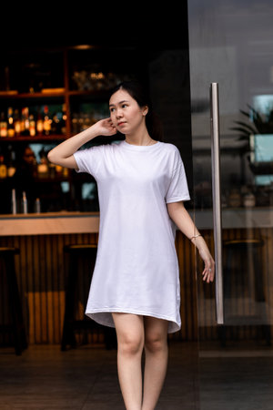 Portrait of a beautiful Asian woman with a serene expression, shirt dress mockup template imageの写真素材