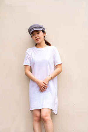 Asian model poses elegantly for a portrait in a scenic location, shirt dress mockup template imageの写真素材