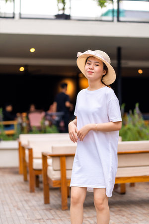Portrait of an Asian woman with a serene expression in a picturesque location, shirt dress mockup template imageの写真素材