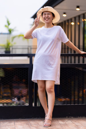 A beautiful Asian woman posing for portrait photography in a stunning location, shirt dress mockup template imageの写真素材