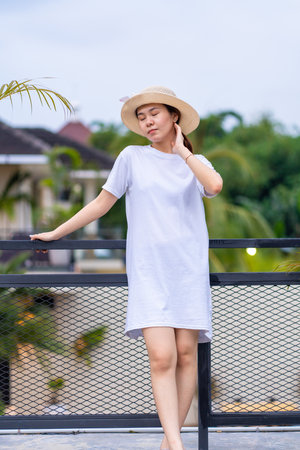 A captivating portrait of an Asian woman in a striking pose, shirt dress mockup template imageの写真素材