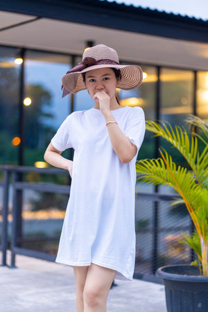 A captivating Asian woman captured in the perfect pose for portrait photography, shirt dress mockup template imageの写真素材