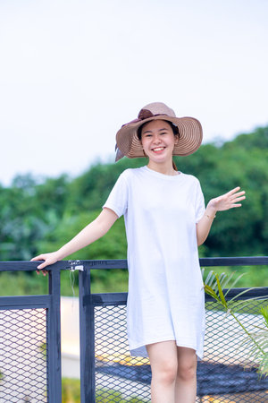 A beautiful smiling asian woman posing for portrait photography in a natural setting, shirt dress mockup template imageの写真素材
