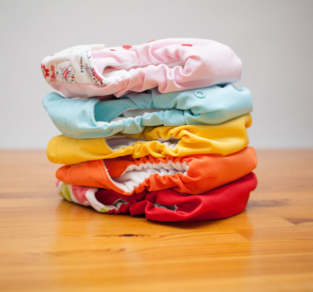 Stack of eco cloth diapers on a wooden tableの写真素材