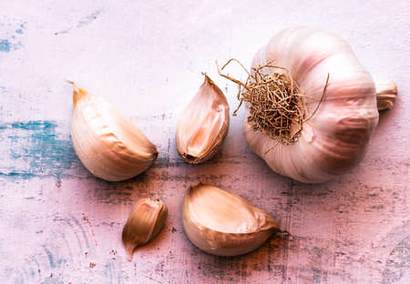 Whole garlic and garlic cloves on a light backgroundの写真素材