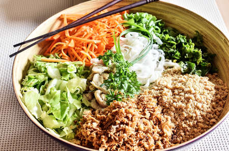 BÃºn bÃ² Nam Bá», a salad of thin rice noodles, lettuce, fried beef, onions, bean sprouts and other vegetables and herbs, topped with broth and sprinkled with crushed peanuts and fried shallots.の写真素材