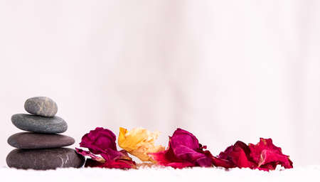 Relaxing still life with stones and flower petalsの写真素材