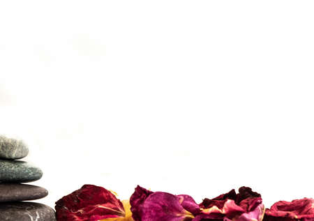 Relaxing still life with stones and flower petalsの写真素材