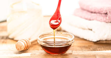 Honey massage, still life with honey, towels and a candleの写真素材