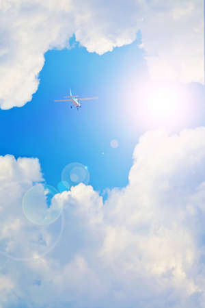 plane hurtling toward the sun in the cloudsの写真素材