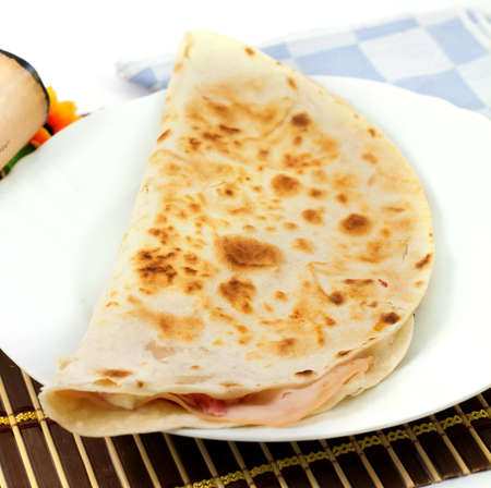 tasty flatbread with ham and mozzarella cheeseの写真素材
