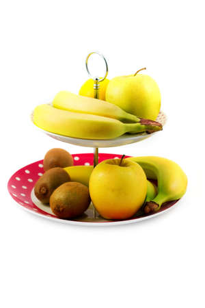 mix of fruits, bananas, apples and kiwi fruit in a trayの写真素材