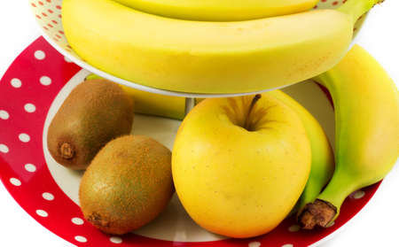 mix of fruits, bananas, apples and kiwi fruit in a trayの写真素材