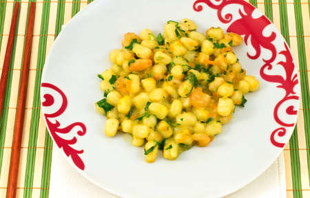 gnocchi with shrimp sauce, parsley and carrotの写真素材