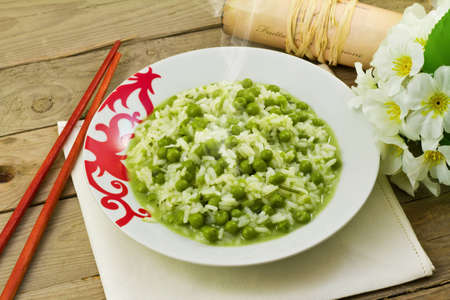 delicious dish of rice with fresh green peasの写真素材
