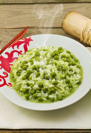 delicious dish of rice with fresh green peasの写真素材