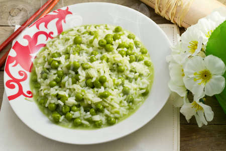 delicious dish of rice with fresh green peasの写真素材