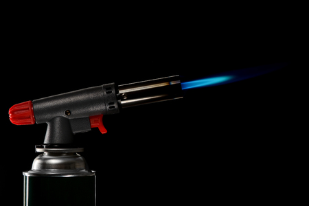 gas burner with flame on black backgroundの写真素材